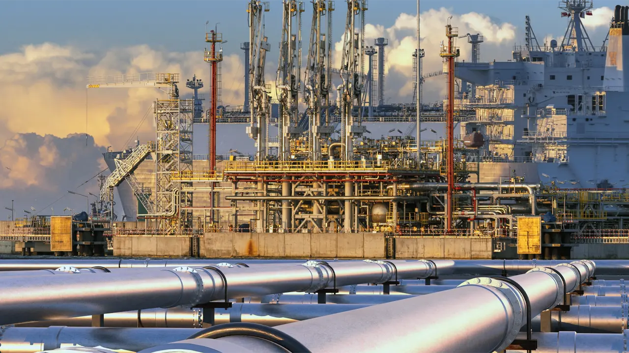 Industrial LNG facility with metallic pipelines and refinery towers processing liquefied natural gas.