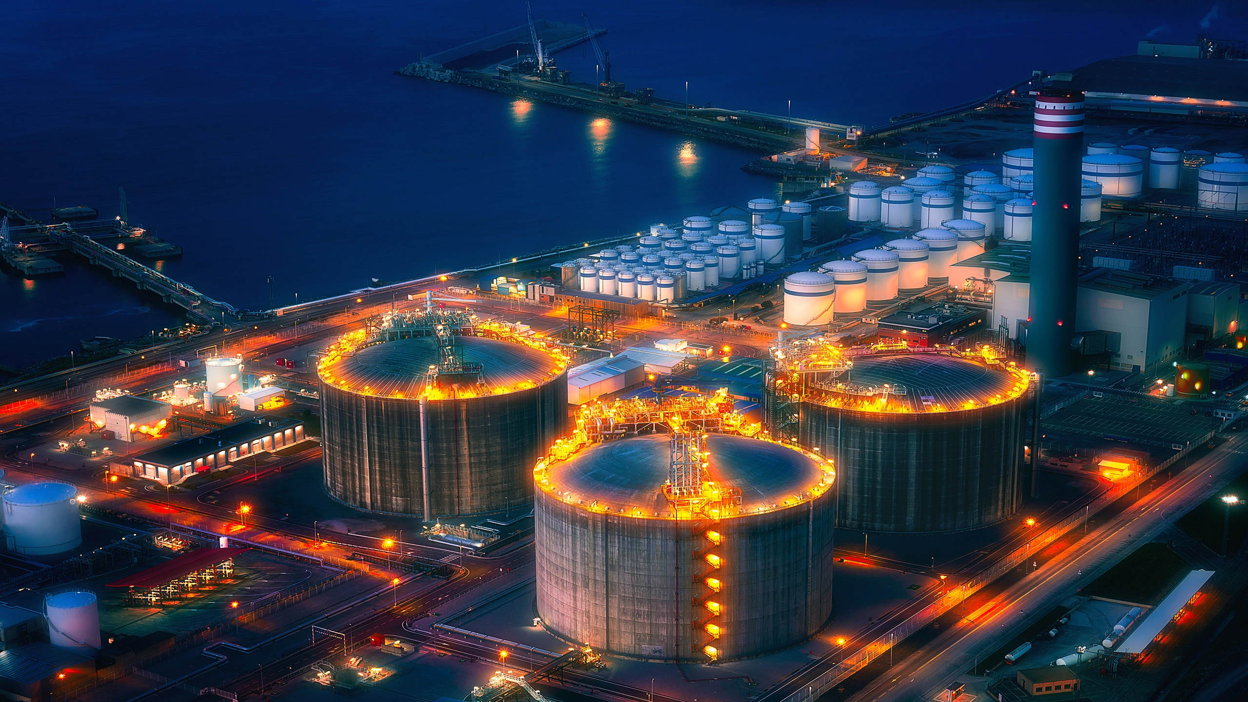 LNG plant with shipping docks at night from the air