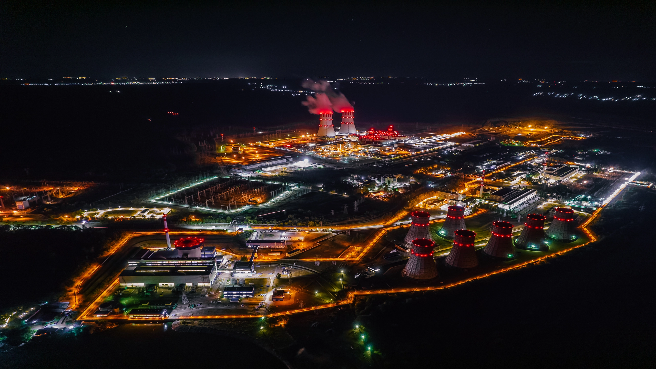 Night time with nuclear power plant shown from the air