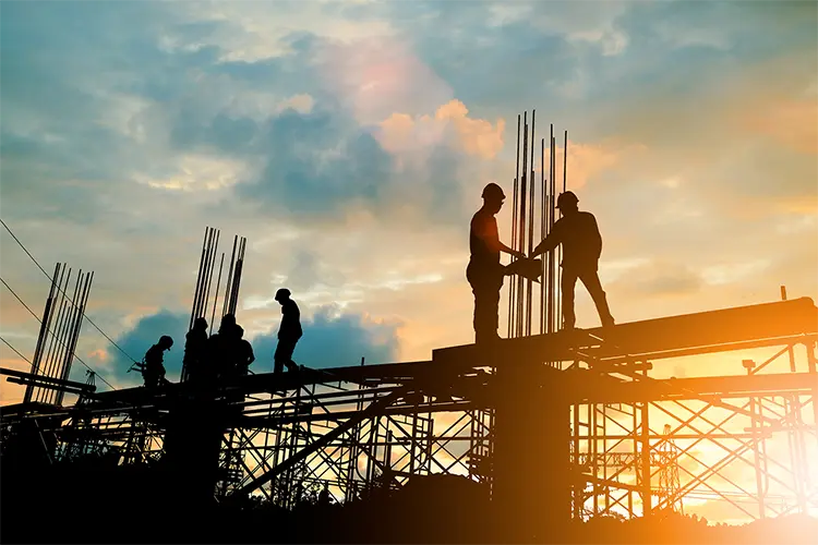 Construction crew working on industrial project site highlighting active labor demand.